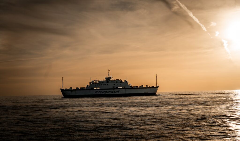 Ferry boat sailing on the ocean at sunset