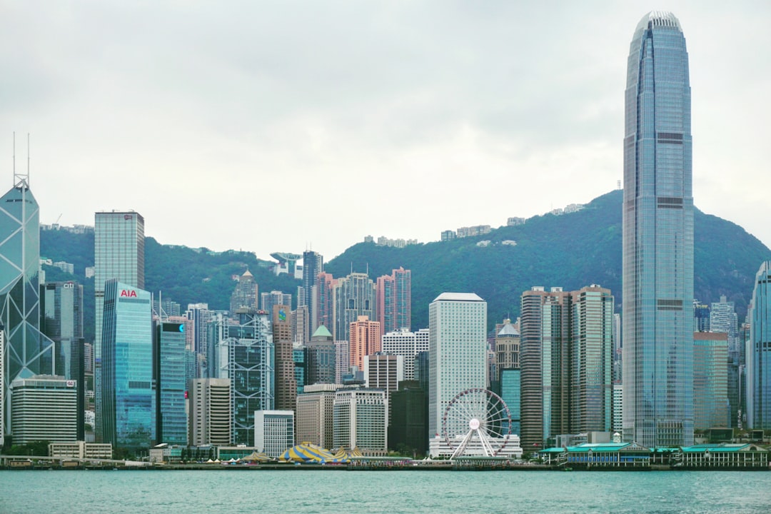 Modern city skyline with skyscrapers and mountains.