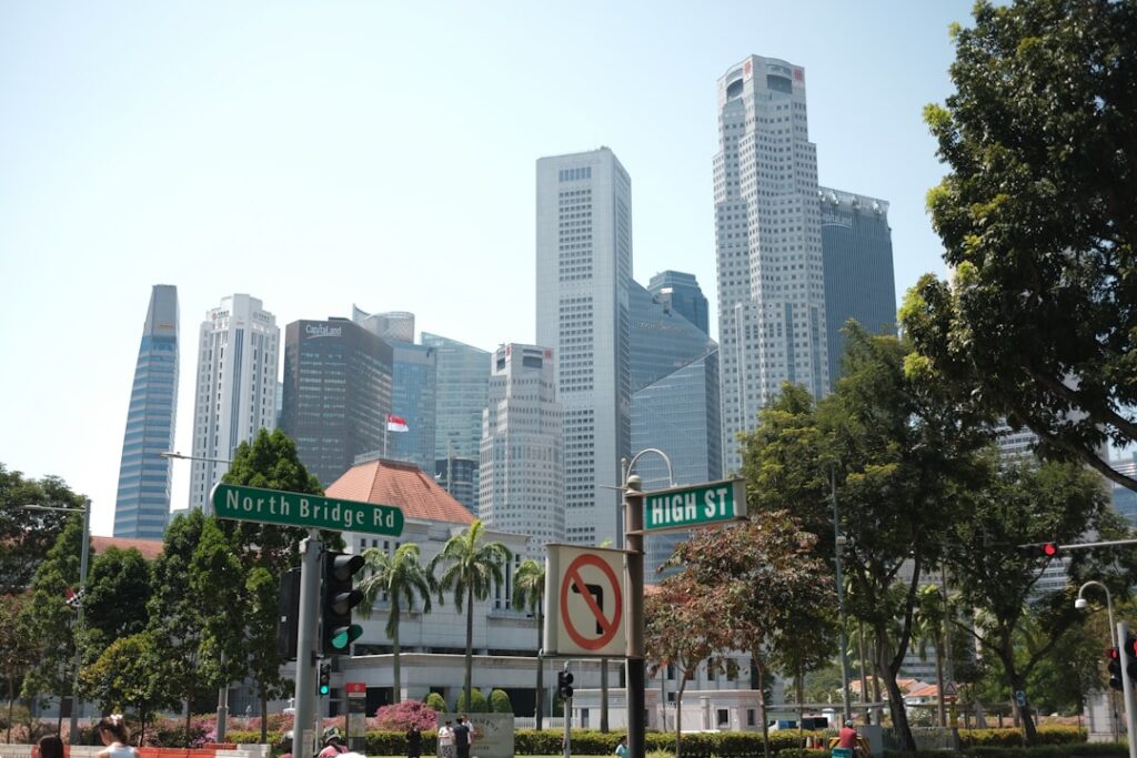 Modern skyscrapers in a bustling city with trees.