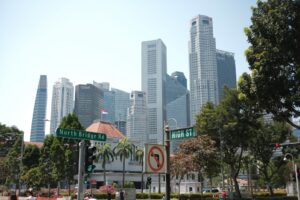 Modern skyscrapers in a bustling city with trees.